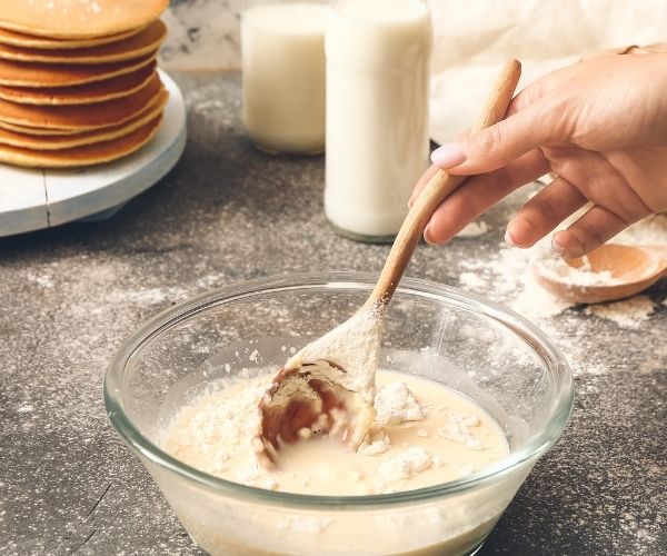 Stir wet ingredients into dry until just combined. Be careful not to over mix or the pancakes will be heavy.